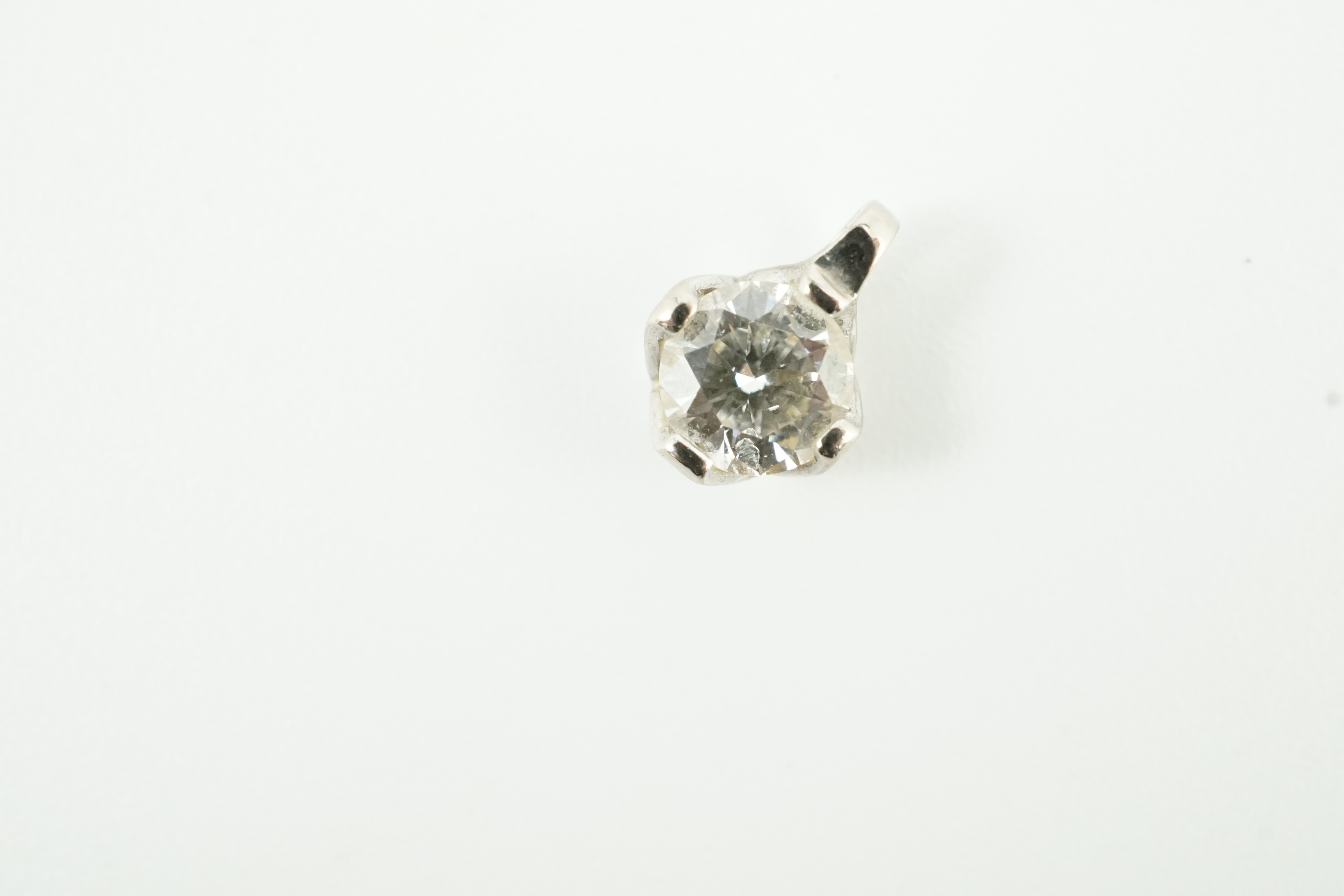 A modern 18ct white gold and solitaire diamond set pendant, gross weight 0.4 grams, stone diameter 5.1mm.